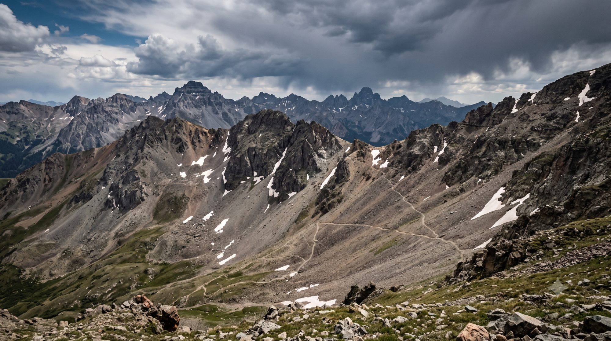 A jagged San Juan Mountains high alpine pass with lingering snow, the Hardrock 100 course